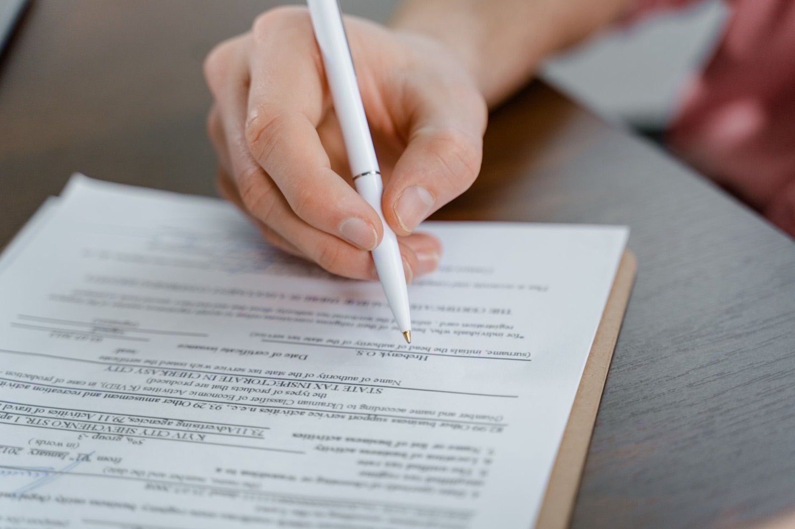 Founder documents and a certified translation set out before a notary appointment.