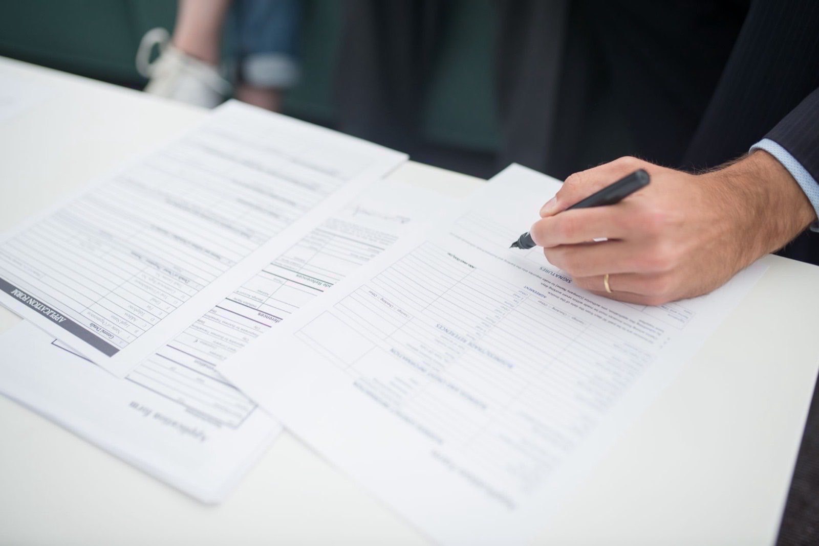 Founder documents and a certified translation set out before a notary appointment.